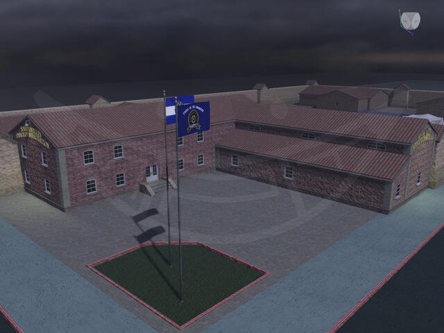 A two-story L-shaped brick building with a slanted clay shingle roof on one end.