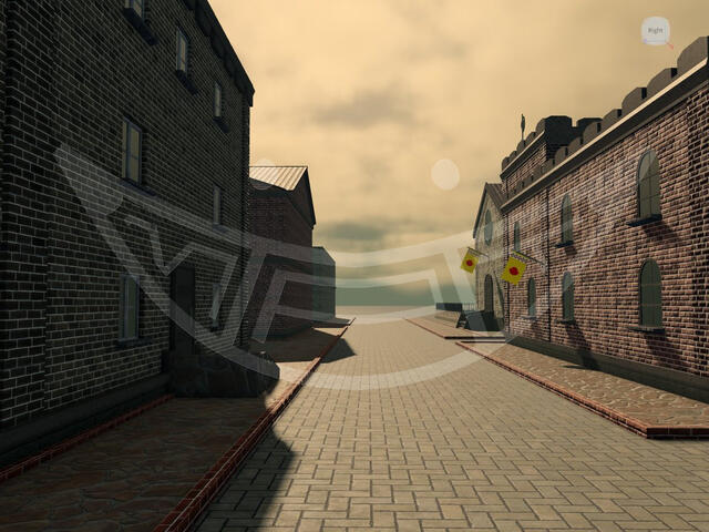 A pavement road lined with several brick buildings.