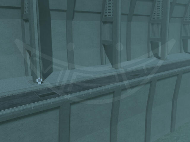 A large coastal concrete structure. There is a road along the edge of it lined with sewer grates.